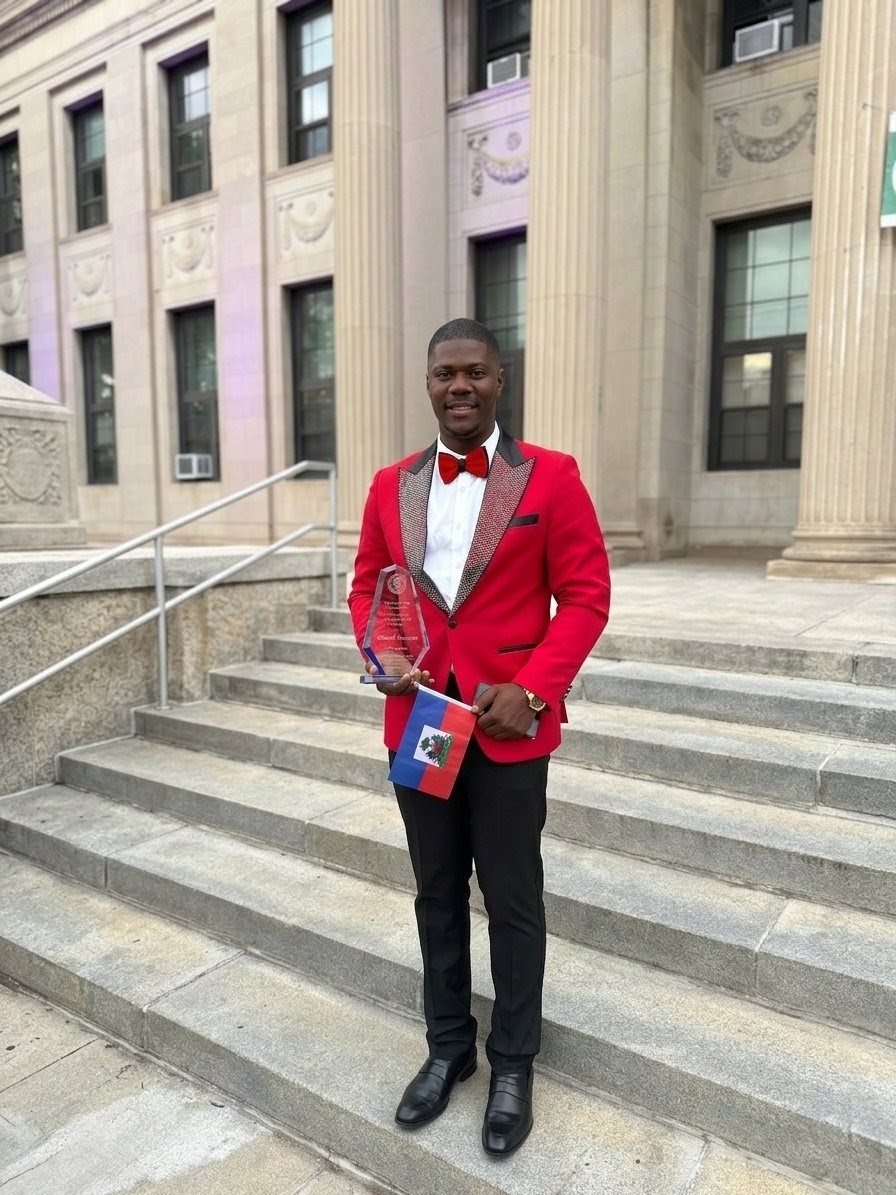 Cliffson Jeanpaul holding award